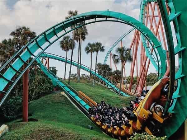 riders swoosh up and down in a loopy rollercoaster